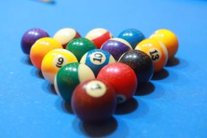 a group of billiard balls on a blue table at The Park Lane Hotel in Krishnagiri