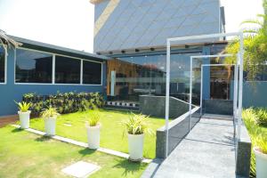 a building with potted plants in front of it at The Park Lane Hotel in Krishnagiri