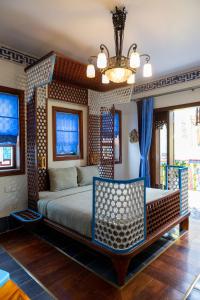 a bedroom with a large bed with a blue chair at Thien Y Villas in Hue +77 photos
