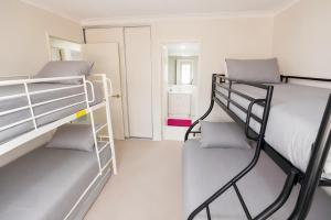 two bunk beds in a small room with a mirror at Midland Haven - Midland WA in Midland Junction
