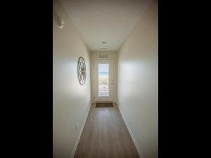 an empty room with a hallway with a door at Ohana Tides Home in Holden Beach