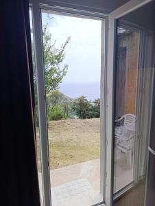 a sliding glass door with a view of the ocean at Monaco' hills appartement in Roquebrune-Cap-Martin