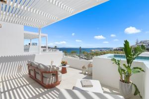 a villa with a view of the ocean at Alexandros Apartments in Naousa