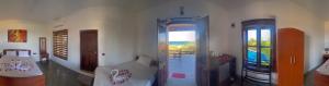 a living room with a couch and a window at Whisky Point Surf Cabanas in Ampara
