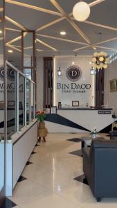 a lobby of a hotel with a sign on the wall at BIN DAOD Hotel Syariah in Meulaboh