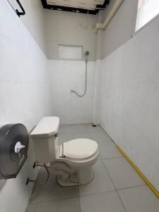 a bathroom with a toilet in a room at Like A Friend Hostel in Thong Sala