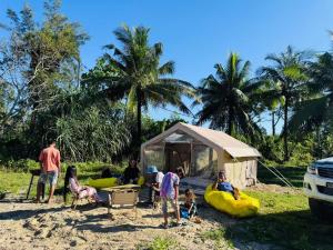 a group of people standing in front of a tent at Luxary Tent in Kudat