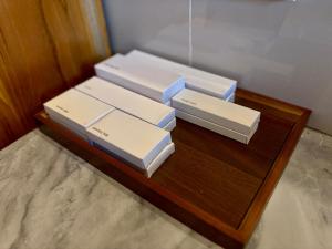 four white boxes sitting on a wooden table at Atta Residence by Manara in Seraya