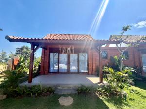 a house with a gate in the yard at Atta Residence by Manara in Seraya +20 photos