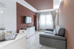 a living room with a couch and a tv at APART-HOTEL PRESiDENT 2 in Ulcinj