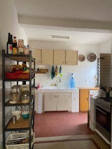 a kitchen with white cabinets and a stove top oven at Malika Surf House in Dakar