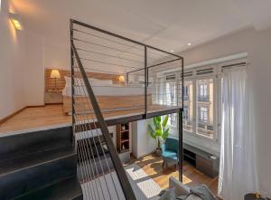 a room with a staircase leading to a loft at FLATSHARING - SPADARI Duomo Suites in Milan