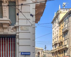 two buildings are next to each other on a street at FLATSHARING - SPADARI Duomo Suites in Milan +156 photos