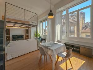 a living room with a table and chairs and a couch at FLATSHARING - SPADARI Duomo Suites in Milan