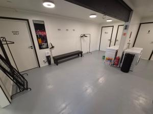 a empty room with a row of doors and a bench at Camp Mefjord in Senja