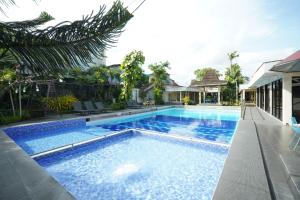 an image of a swimming pool in a house at Hotel Grand Rosela in Yogyakarta