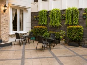 a patio with chairs and a table in front of a building at Wisma Pelangi 5 in Jakarta