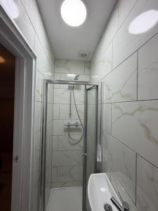 a bathroom with a shower and a sink at Upton House in Chatham