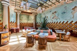 a restaurant with tables and chairs and a mural at Hotel España Ocean Drive - Newly Renovated in Barcelona