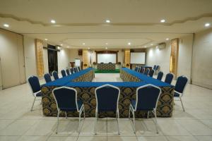 a large meeting room with a long table and chairs at Hotel Grand Rosela in Yogyakarta +24 photos