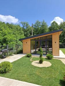 a house with a garden and a playground at Nordic Cabin in Bughea de Jos