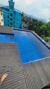 a large blue swimming pool on top of a building at Buddha Premium Stays in Guwahati
