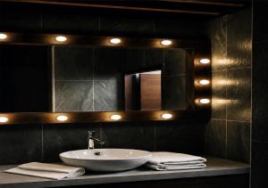 a bathroom with a sink and a mirror at 境域Loft自助民宿 in Kaohsiung