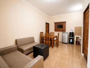 a living room with a couch and a table at New Dgyp Ciater Resort in Ciater