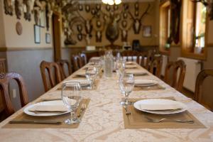 a long table with plates and wine glasses on it at Hárs Fogadó in Ötvös