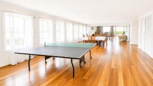 a ping pong table in the middle of a living room at 18 On Main in Wooli