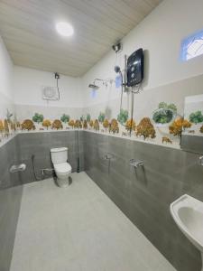 a bathroom with a toilet and a sink at Misty Garden in Maskeliya +16 photos