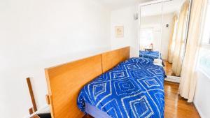 a bedroom with a bed and a wooden headboard at 18 On Main in Wooli