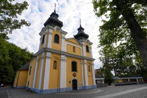 a yellow and white church with two towers at Mátraverebély-Szentkút Nemzeti Kegyhely in Mátraverebély