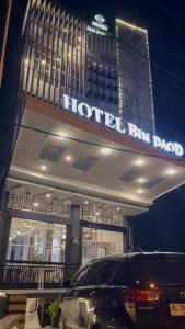 a hotel with a car parked in front of it at BIN DAOD Hotel Syariah in Meulaboh