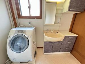 a bathroom with a washing machine and a sink at Laina 31 in Sumoto +20 photos