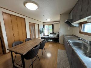 a kitchen with a table and chairs in a room at Laina 31 in Sumoto