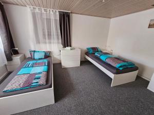 a bedroom with two beds and a window at Hofruhe in Neresheim