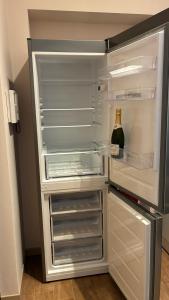 an empty refrigerator with a bottle of wine in it at Il Glicine in Cusano Milanino