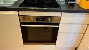 a kitchen with an oven with a clock on it at Il Glicine in Cusano Milanino +17 photos