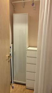 a closet with a glass door and a white refrigerator at Il Glicine in Cusano Milanino