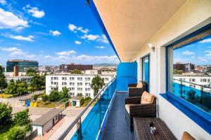 a balcony with a view of a city at Red Hotel Accommodation in Cluj-Napoca