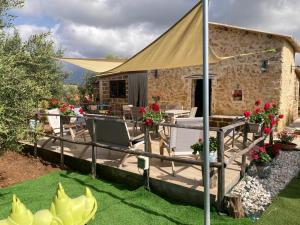 a house with a wooden deck with a tent at Lovely Country House in Trappeto