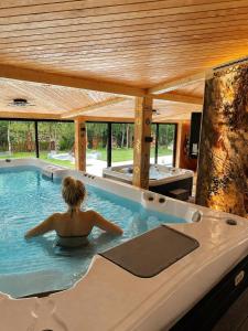 a woman in a hot tub in a house at Kraina Smaku in Zakopane