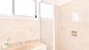 a bathroom with a sink and a shower at On The Beach in Wooli +7 photos