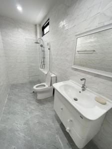 a white bathroom with a sink and a toilet at Chiang Rai Home with Full Kitchen in Ban Pa Sang (1) +16 photos