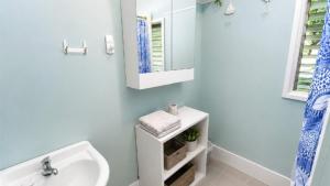 a bathroom with a sink and a mirror at The Blue Groper in Minnie Water +6 photos