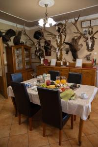a dining room with a table with food on it at Hárs Fogadó in Ötvös +23 photos