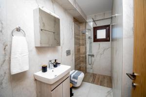 a white bathroom with a sink and a shower at Ligiades 945 in Ligiades +38 photos