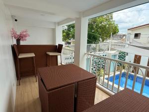 a balcony with a table and a view of a pool at Casa Sakura 2 in Calamba