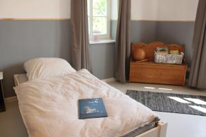 a book sitting on top of a bed in a room at Ferienwohnung Hof Alms in Uelzen